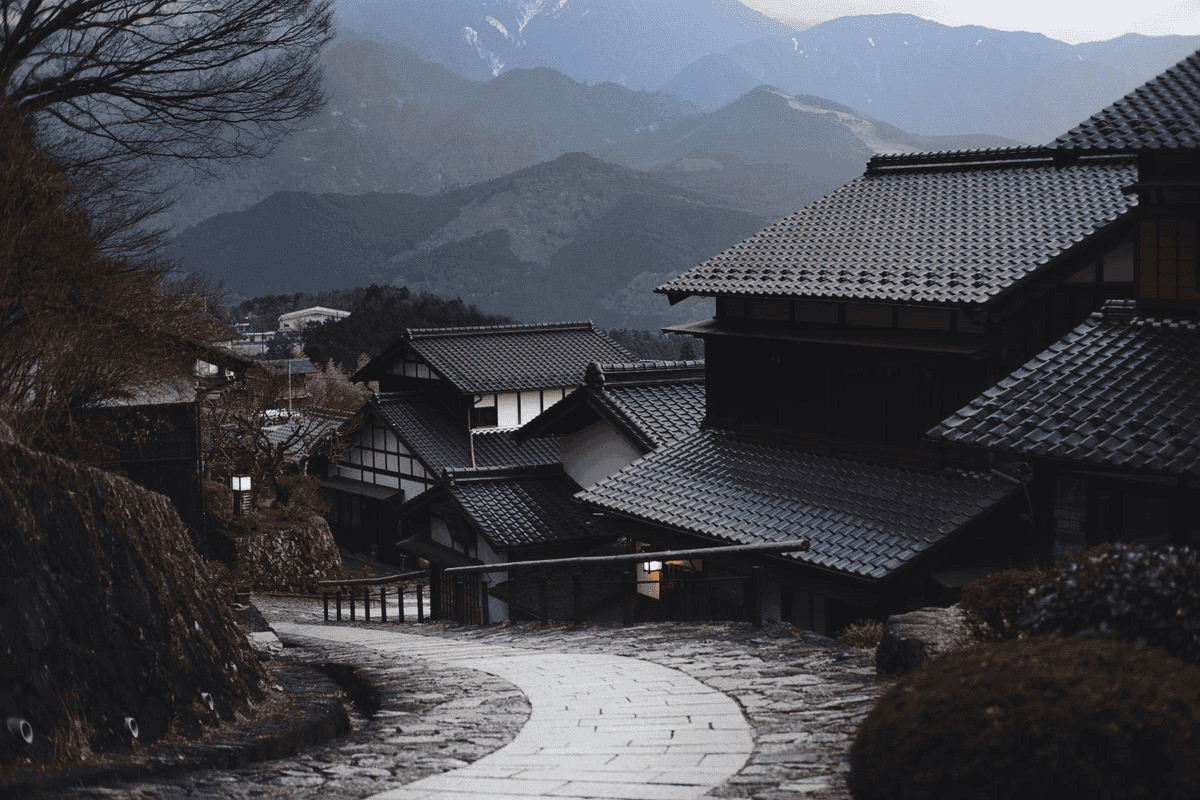 Mountain village with tiled roofs and a winding stone road